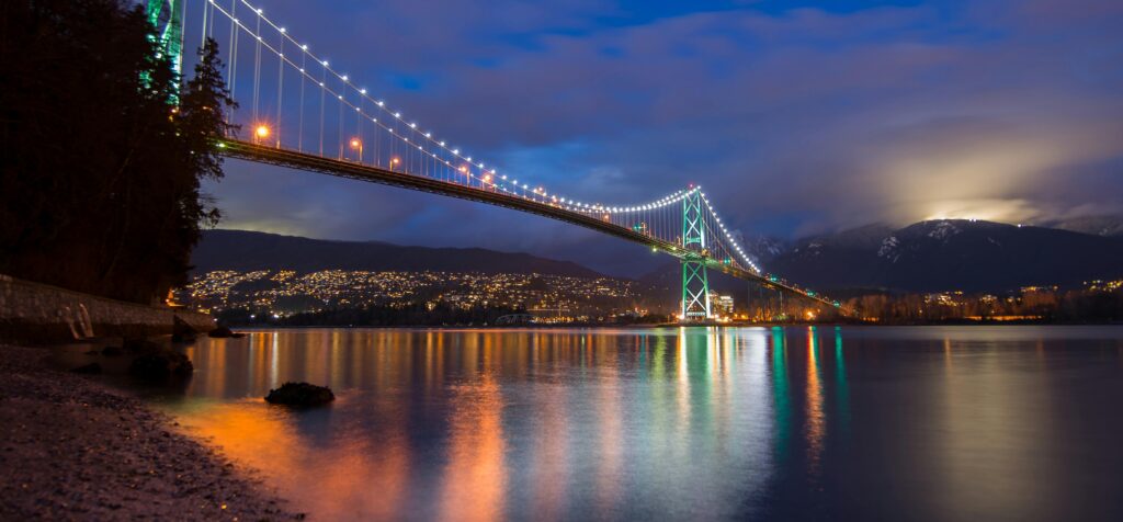 pexels-photo-414462-414462 Stunning night view of the illuminated Lions Gate Bridge in Vancouver, reflecting on calm waters.